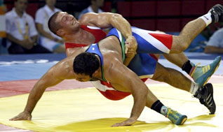 Khasan Baroev of Russia (in red) fights Masoud Hashem Zadeh of Iran during their 120kg men's Greco-Roman wrestling 1/8 final match at the Beijing 2008 Olympic Games August 14, 2008.